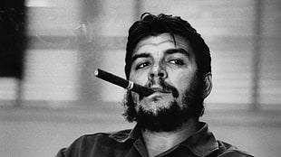 grayscale photo of man smoking tobacco