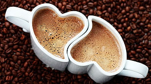 two white ceramic heart shaped coffee mugs