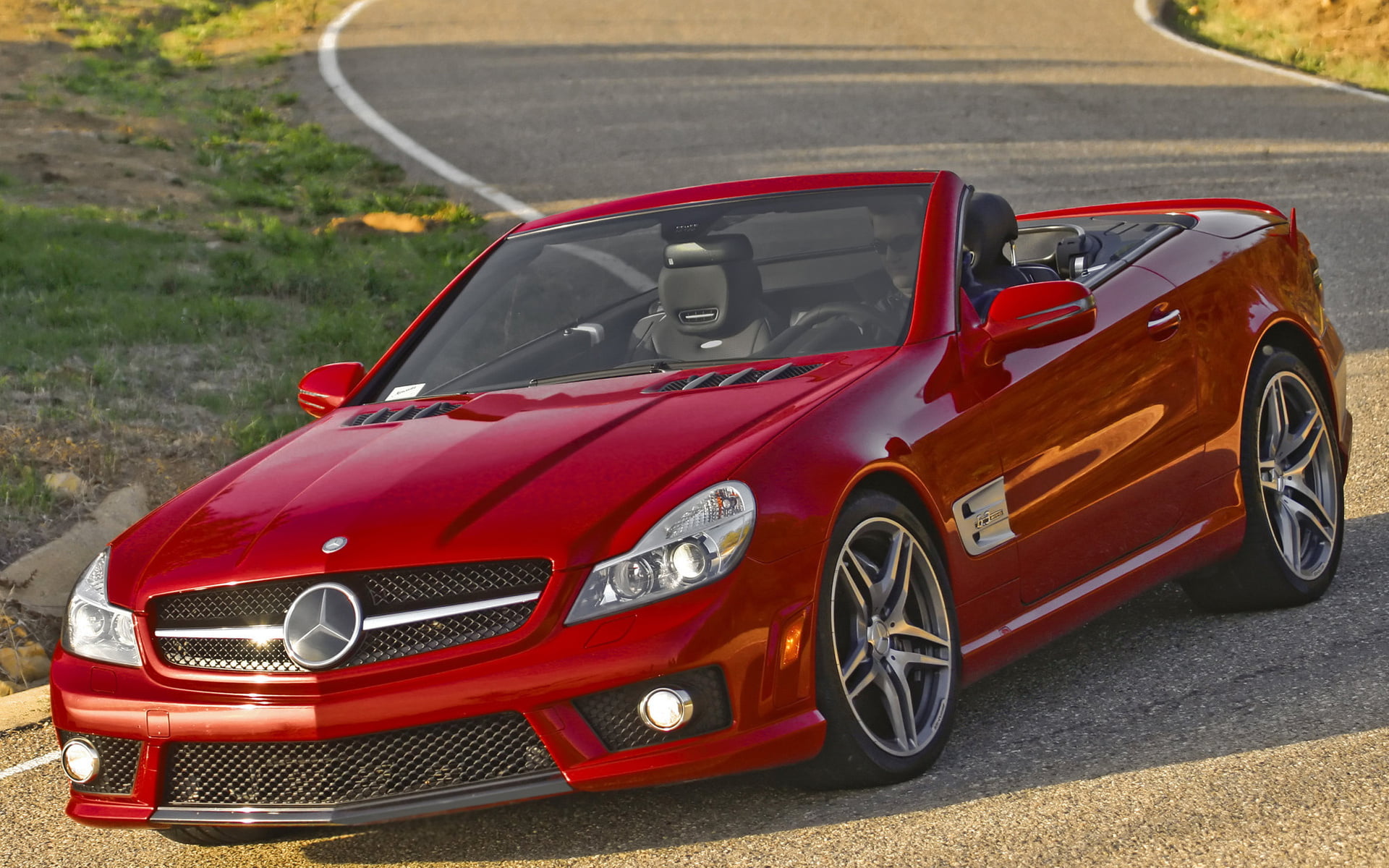 red Mercedes-Benz convertible coupe on road