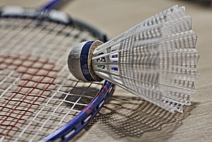 shuttlecock on tennis racket