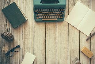 blue manual typewriter; black framed eyeglasses; white ruled notebook HD wallpaper