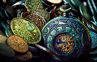 closeup photo of mechanical pocket watch and coins