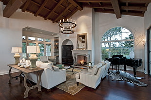 living room set with grand piano and lighted fireplace