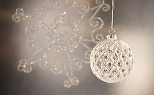 selective focus photography of round glass hanging decor
