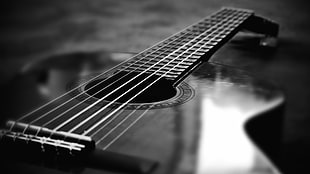 grayscale photography of dreadnought acoustic guitar