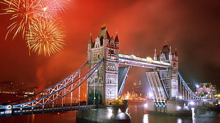 person showing London Tower bridge with fireworks