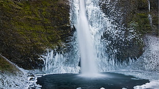 water falls surrounded by sno