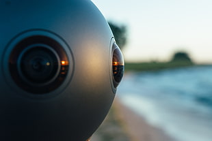 close-up photography of 360 camera on seashore