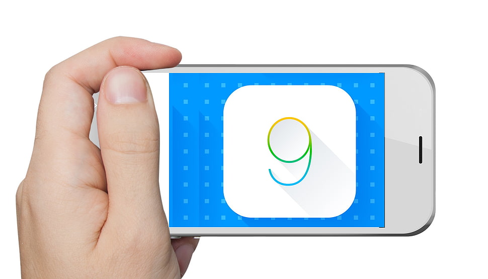 white touch screen phone displaying 9 HD wallpaper