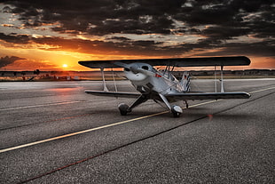 white bi-plane during sunset