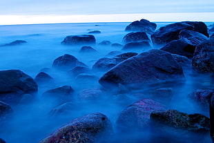 time-lapse photography of fog on large rocks HD wallpaper
