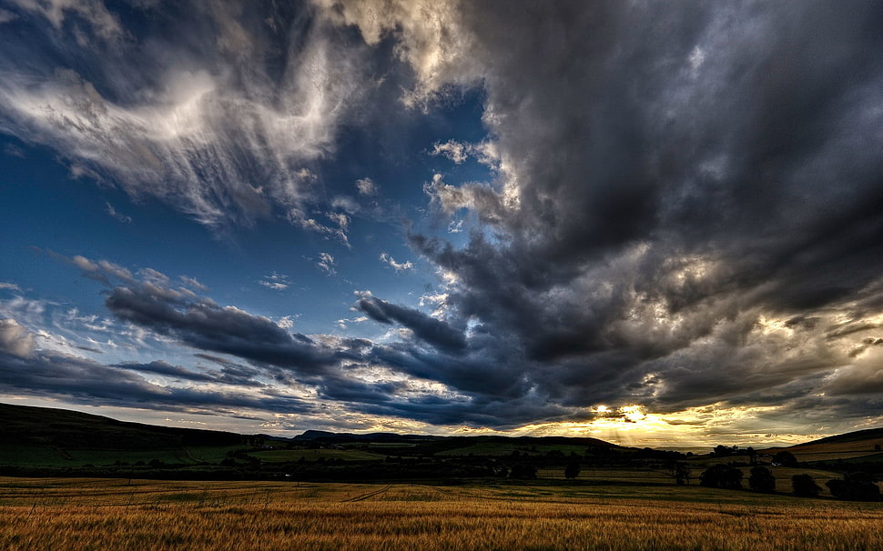 dark clouds surrounding dessert HD wallpaper