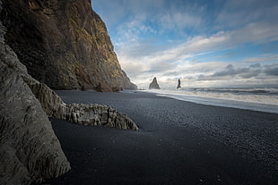 brown stone, beach, black sand, cliff, nature HD wallpaper
