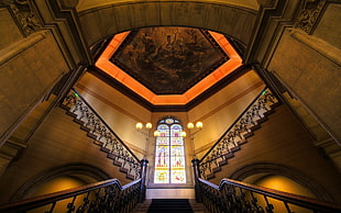 photography of stairs and ceiling light inside the building