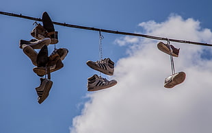 assorted-brand shoes on grey steel wire