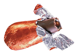 photography of sliced chocolate bar covered with orange and silver-colored foil