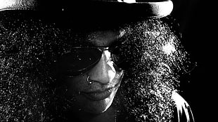 person wearing black hat and black framed aviator sunglasses