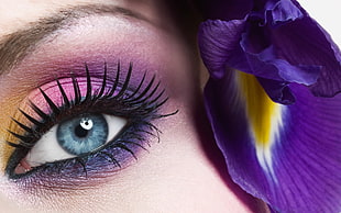 purple bell flower near woman's face with smoky purple eyeshadow