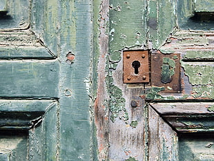 green wooden door with brown key hole
