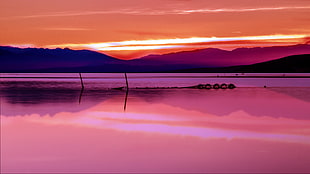 silhouette of mountains surrounded with water during sunrise, leucate