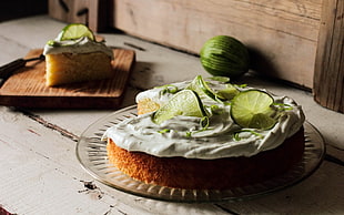cake with lime toppings served on clear glass plate