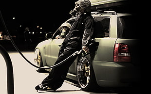 man wearing gas mask filling car with gas