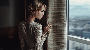 woman in gray long-sleeved shirt looking at window HD wallpaper