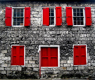 six gray and red windows of building