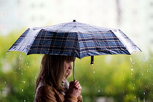 woman with umbrella under the rain close up photography