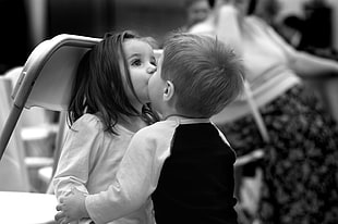grayscale photography of boy and girl kissing