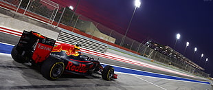 photo of black and red Total RedBull racing kart on racing arena during night time HD wallpaper