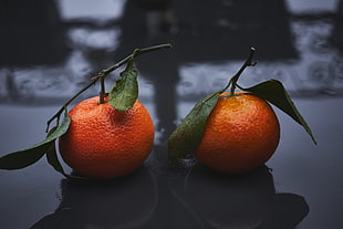 two round red citrus fruits