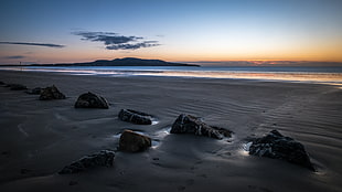 black stone near grey sand beside seashore during daytime, dublin, ireland