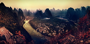 bird's eyeview photo of body of water surrounded by mountain