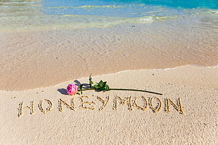 white sand beach with honeymoon letter