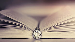 round silver-colored pocket watch, books, watch