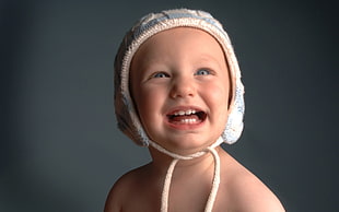 baby in white knitted cap