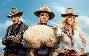 man wearing brown cowboy hat carrying a sheep