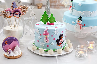 blue and white snowman and penguin cake