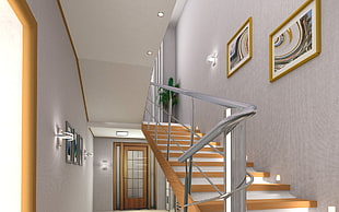 stainless steel hand rail beside brown wooden staircase