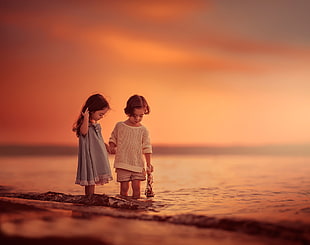 two children on seashore HD wallpaper