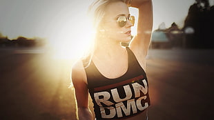 woman wearing black RUN DMC-printed tank top