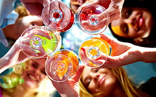 selective focus photography of five person holding wine glasses