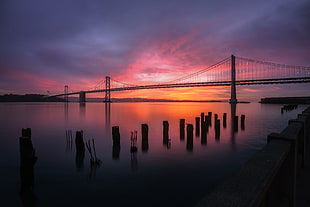 photograph of silhouette of bridge during sunset