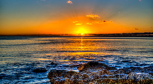 brown rocks in front of seashore during sunset, haleiwa