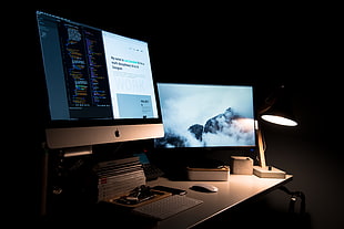 silver iMac, Apple Magic mouse, and Magic keyboard on white desk
