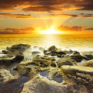 grey stones on seaside during sunset