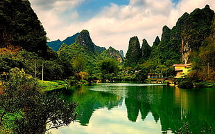 body of water surrounded by rock mountains