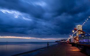 gray sea dock under gray sky during night time