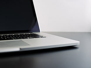 MacBook Pro on black wooden surface